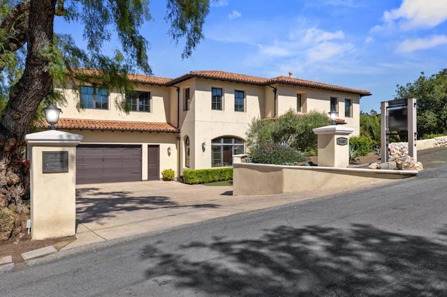 mediterranean / spanish-style home with a garage