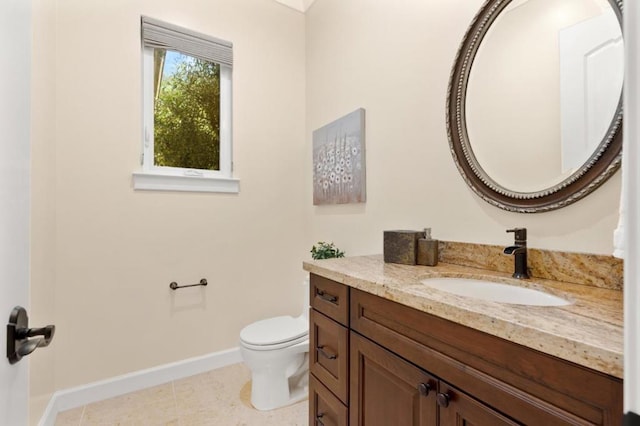 bathroom with toilet, tile patterned flooring, and vanity