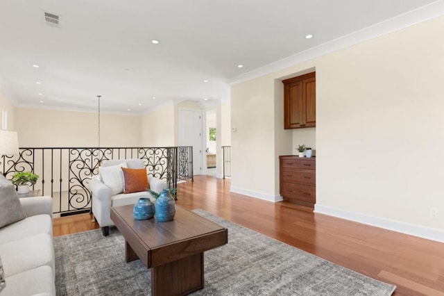 living room featuring hardwood / wood-style floors and ornamental molding