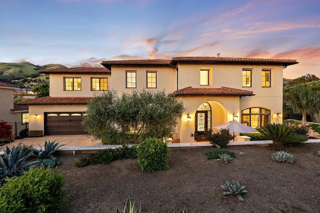 mediterranean / spanish-style house with a garage