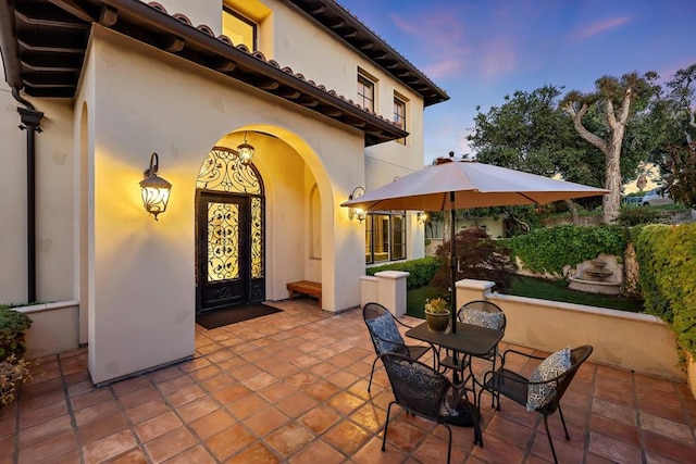 view of patio terrace at dusk