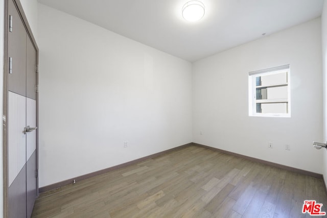 spare room with hardwood / wood-style flooring