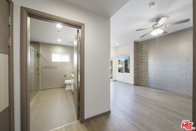 bathroom featuring toilet, a healthy amount of sunlight, ceiling fan, and hardwood / wood-style flooring