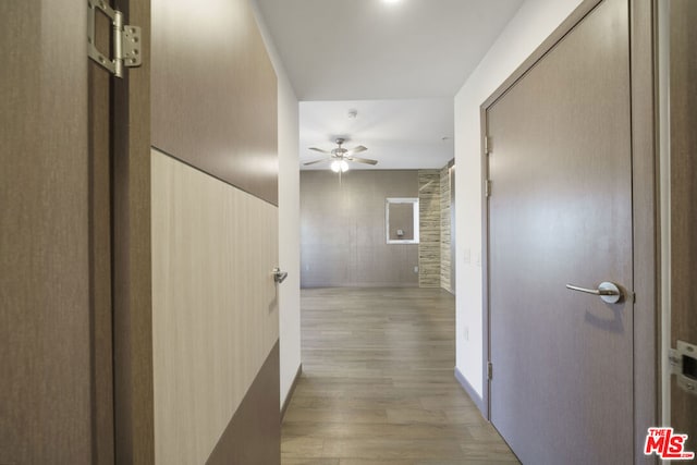 corridor with light hardwood / wood-style floors