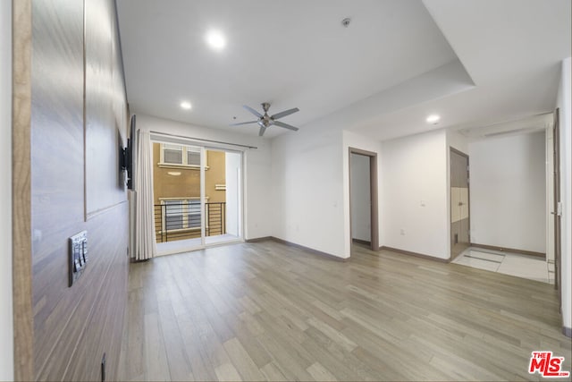 unfurnished living room featuring light hardwood / wood-style floors and ceiling fan