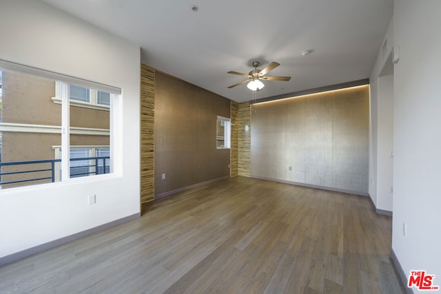 spare room featuring ceiling fan and hardwood / wood-style floors