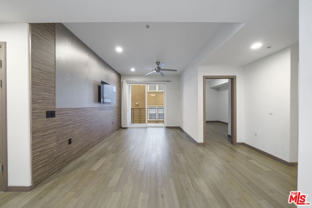 unfurnished living room with ceiling fan and light hardwood / wood-style floors