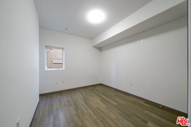 spare room with dark hardwood / wood-style floors