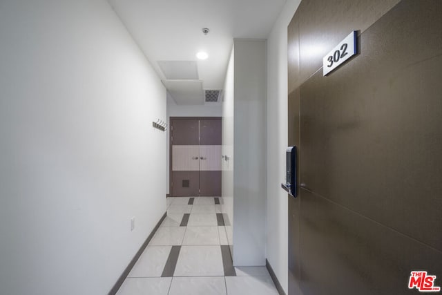 corridor featuring light tile patterned floors