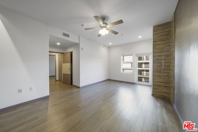 unfurnished living room with hardwood / wood-style flooring and ceiling fan