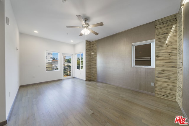 unfurnished room featuring ceiling fan and light hardwood / wood-style floors