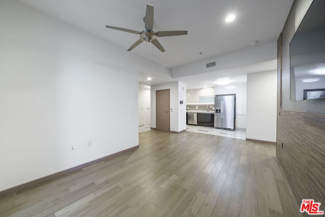 unfurnished living room with ceiling fan and hardwood / wood-style flooring