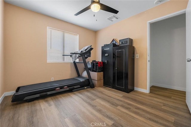 exercise room featuring ceiling fan and wood-type flooring