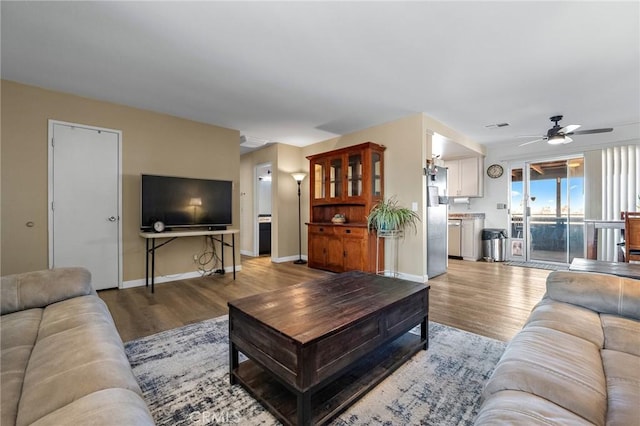 living room with ceiling fan and hardwood / wood-style floors