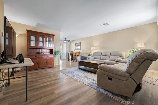 living room featuring ceiling fan and wood-type flooring