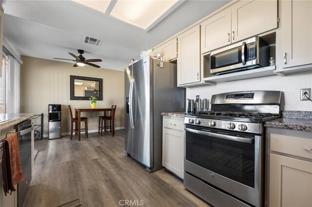 kitchen featuring ceiling fan, dark hardwood / wood-style floors, and stainless steel appliances