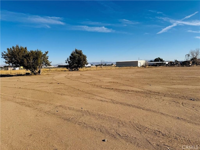 view of yard with a rural view