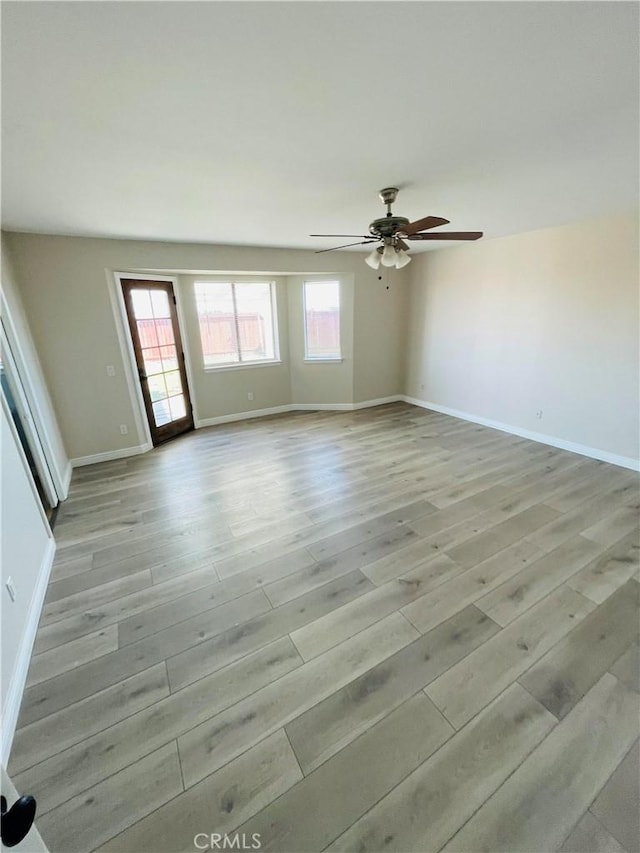 unfurnished room with light hardwood / wood-style floors and ceiling fan