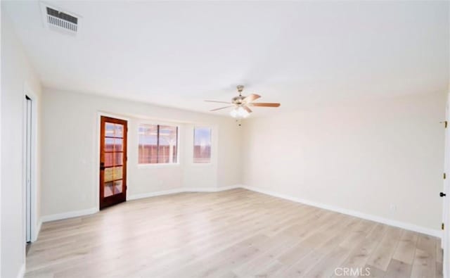 empty room featuring ceiling fan and light hardwood / wood-style floors