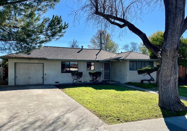 ranch-style house featuring a garage and a front yard