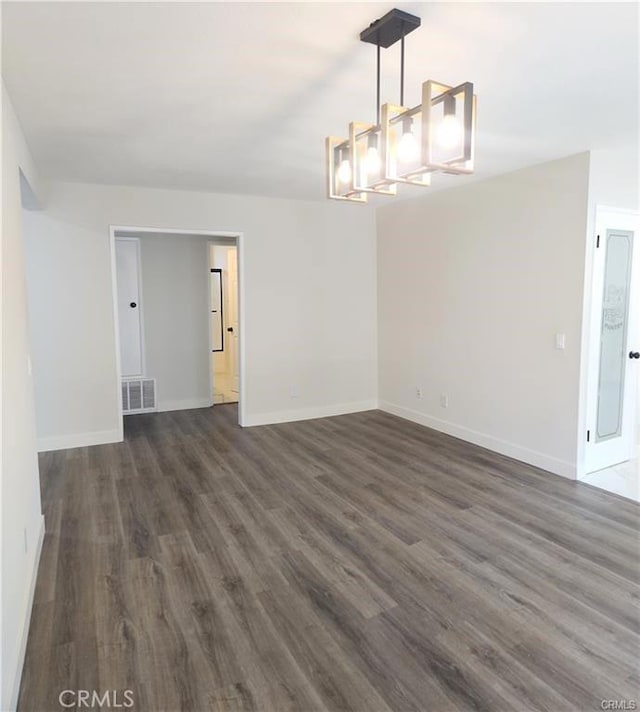 spare room with dark hardwood / wood-style floors