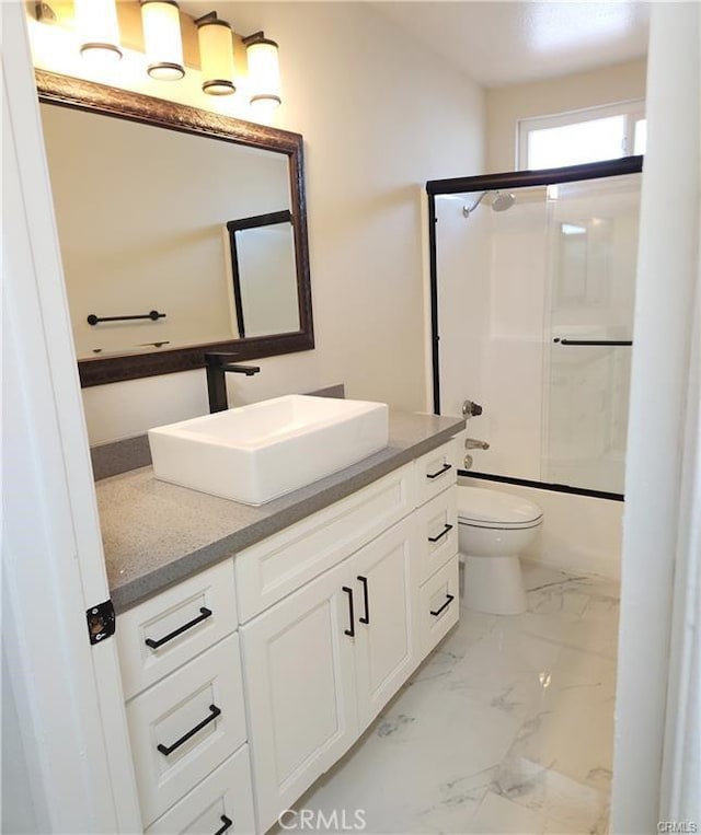 full bathroom with toilet, bath / shower combo with glass door, and vanity