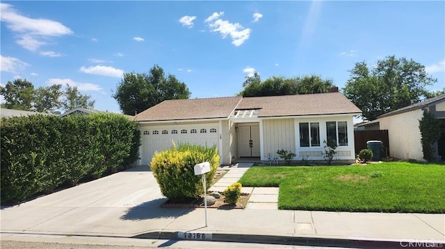 ranch-style house with a front lawn and a garage