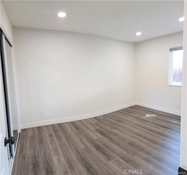 spare room with dark hardwood / wood-style flooring