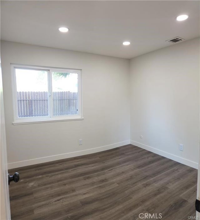 spare room featuring dark wood-type flooring