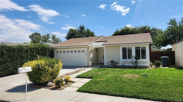 ranch-style house featuring a front lawn and a garage