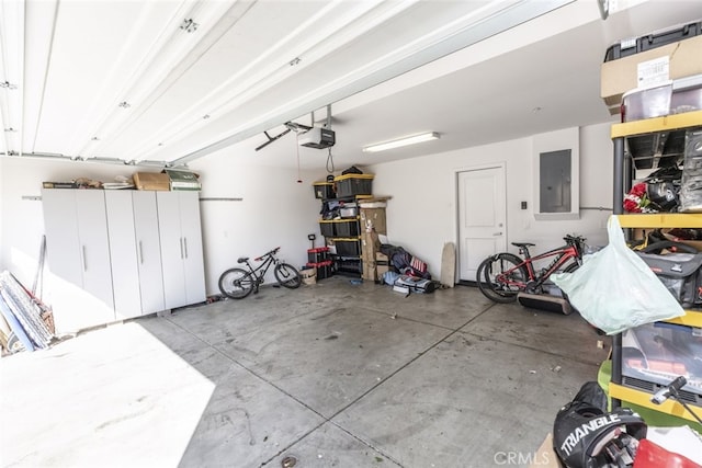 garage with a garage door opener and electric panel