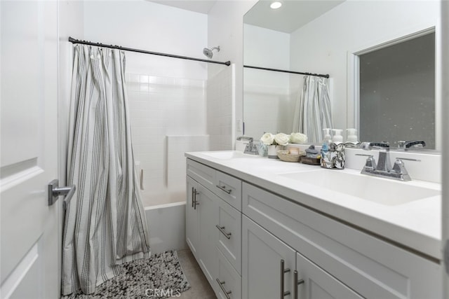 bathroom featuring tile patterned flooring, vanity, and shower / bath combo with shower curtain