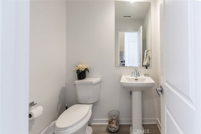 bathroom featuring sink, hardwood / wood-style floors, and toilet