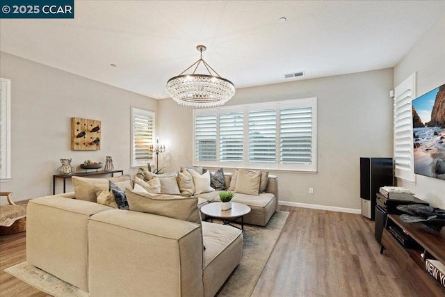 living room featuring hardwood / wood-style floors and a notable chandelier