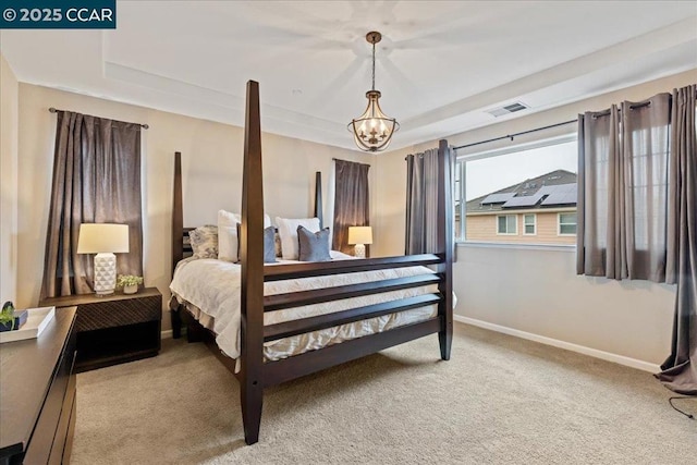 carpeted bedroom featuring an inviting chandelier