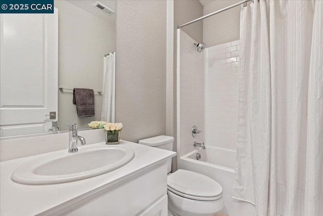 full bathroom with vanity, shower / tub combo, and toilet