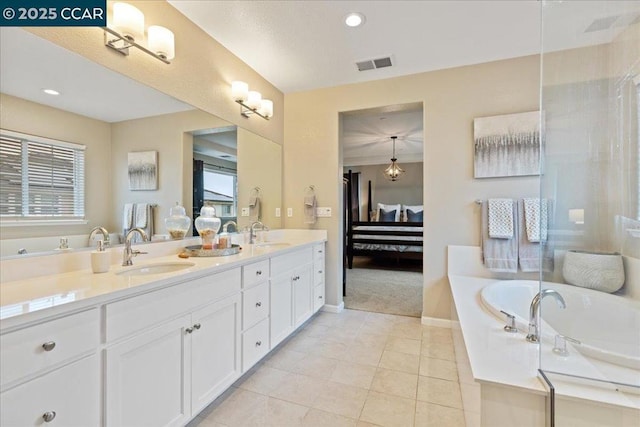 bathroom featuring tile patterned flooring, vanity, and a bathtub