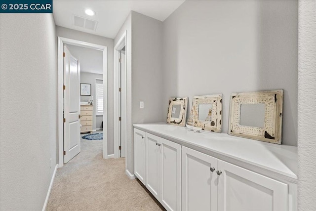 hallway featuring light carpet