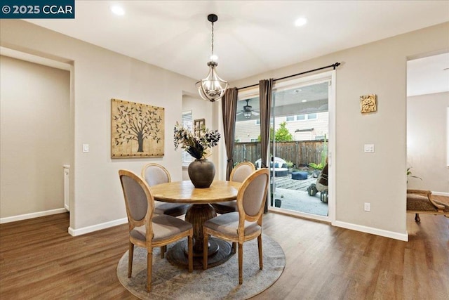 dining room featuring a notable chandelier and dark wood-type flooring