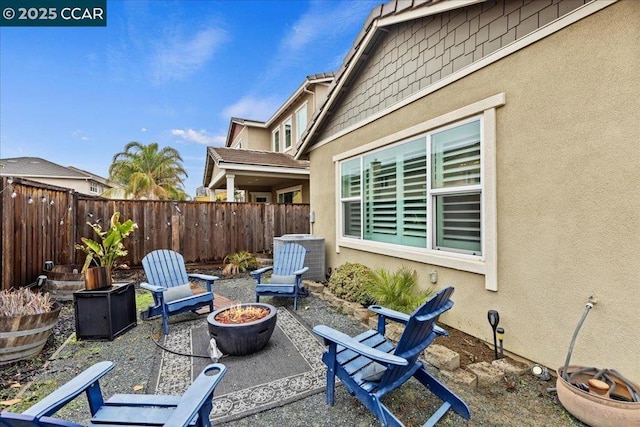 view of patio / terrace featuring central AC unit and an outdoor fire pit