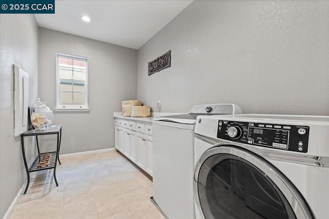 laundry area with independent washer and dryer and cabinets