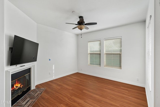 unfurnished living room featuring ceiling fan and wood-type flooring