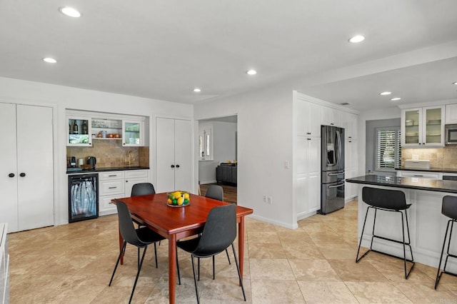 dining space with indoor bar and beverage cooler