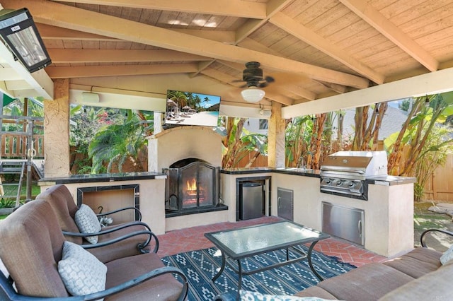 view of patio featuring exterior kitchen, area for grilling, and ceiling fan