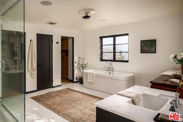 bathroom featuring vanity, tile patterned flooring, and plus walk in shower