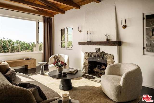 interior space featuring wooden ceiling, dark hardwood / wood-style floors, lofted ceiling with beams, and a fireplace