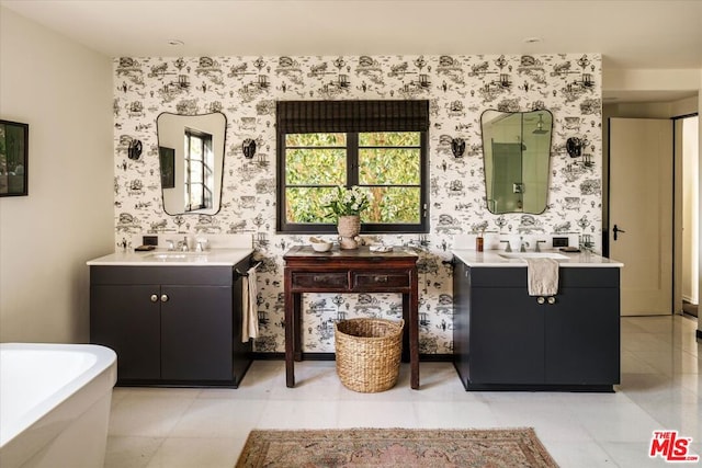 bathroom featuring a tub, vanity, and tile patterned flooring