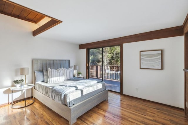 bedroom with wood ceiling, hardwood / wood-style floors, and access to outside