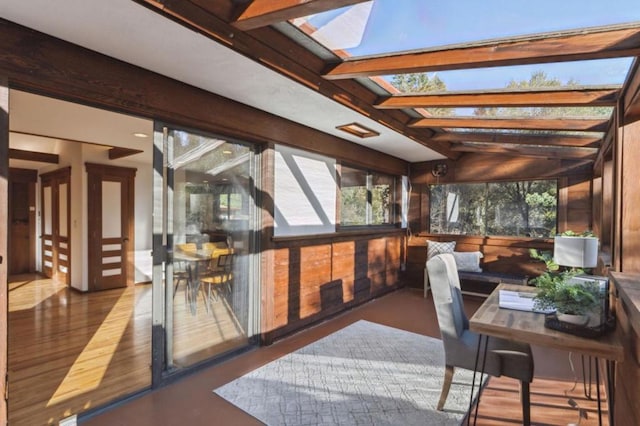 sunroom with vaulted ceiling with skylight