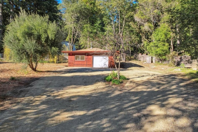 exterior space featuring a garage and an outdoor structure